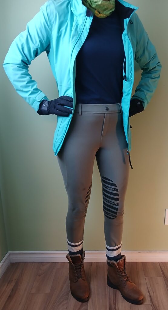 A blue windbreaker layered over a merino top